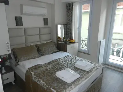 a bedroom with a bed with two towels on it at Best Home Suites Sultanahmet in Istanbul