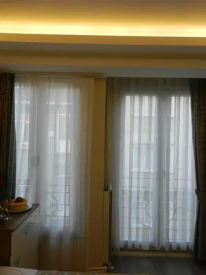 two windows with white curtains in a room at Best Home Suites Sultanahmet in Istanbul