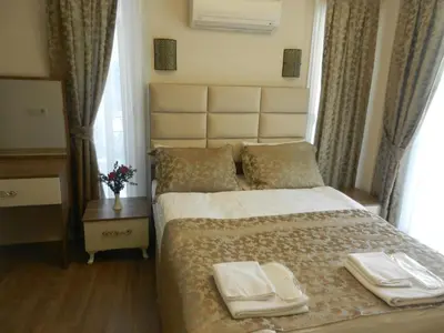 a bedroom with a bed with two white towels on it at Best Home Suites Sultanahmet in Istanbul
