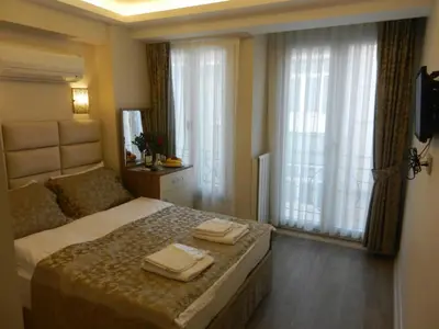 a bedroom with a bed with two towels on it at Best Home Suites Sultanahmet in Istanbul