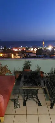 a table on a balcony with a view of the ocean at Best Home Suites Sultanahmet in Istanbul