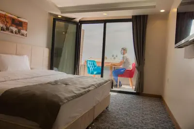 a man sitting at a table in a hotel room at Royal İnci Hotel in Istanbul
