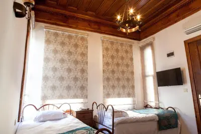 two beds in a room with a window at Lal Hotel Bursa in Bursa
