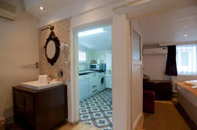 a bathroom with a sink and a mirror and a kitchen at Blue Mosque Suites-Old City Sultanahmet in Istanbul