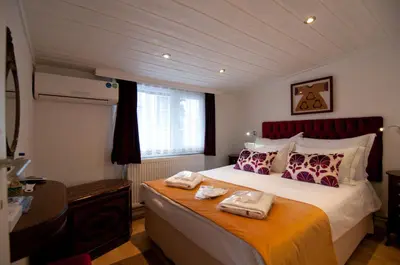a bedroom with a bed with two towels on it at Blue Mosque Suites-Old City Sultanahmet in Istanbul