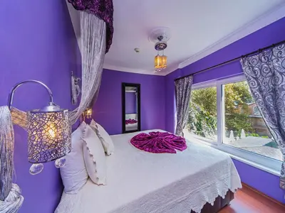 a purple bedroom with a bed and a window at Modern Sultan Hotel in Istanbul