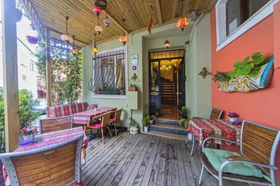 a patio with benches and tables and a building at Modern Sultan Hotel in Istanbul