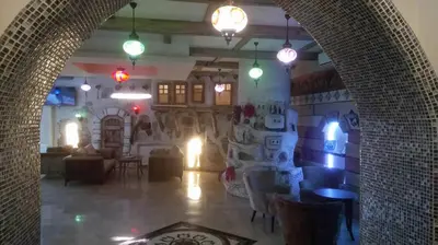 a room with a living room with lights on the wall at Waha Hotel in Bursa