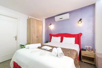 a bedroom with a large bed with a red headboard at Loren Hotel&Suites in Istanbul