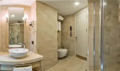 a bathroom with a toilet and a sink and a shower at MARE PARK Hotel & SPA in Istanbul