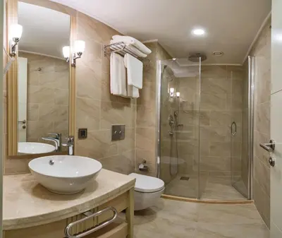 a bathroom with a shower and a sink and a toilet at MARE PARK Hotel & SPA in Istanbul