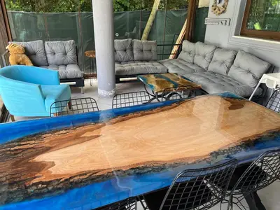 a deck with a wooden table and a couch at Villa Onuk in Sapanca