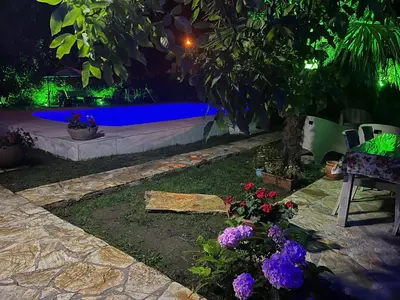 a backyard with a swimming pool at night at Villa Onuk in Sapanca