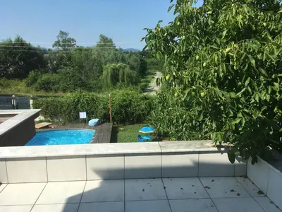 a swimming pool in a yard with a tree at Villa Onuk in Sapanca