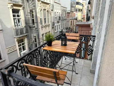 a balcony with a table and chairs on a balcony at Taksim Park in Istanbul
