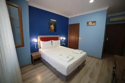 a bedroom with a large bed with blue walls at Taksim Park in Istanbul
