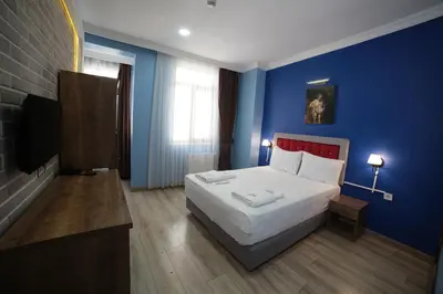 a bedroom with a bed and a blue wall at Taksim Park in Istanbul
