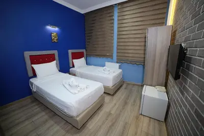 a room with two beds and a tv in it at Taksim Park in Istanbul