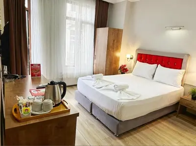 a hotel room with a bed and a tray with a kettle at Taksim Park in Istanbul