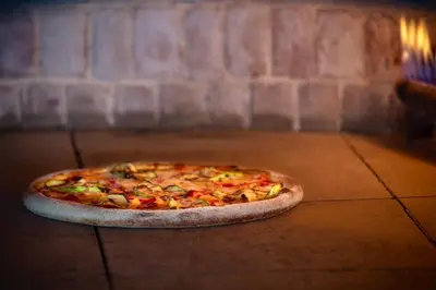 a pizza sitting on the floor in an oven at Metropolitan Hotels Bosphorus - Special Category in Istanbul