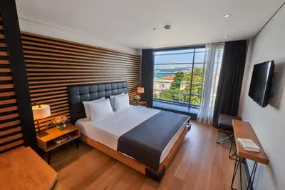 a bedroom with a large bed and a large window at Metropolitan Hotels Bosphorus - Special Category in Istanbul
