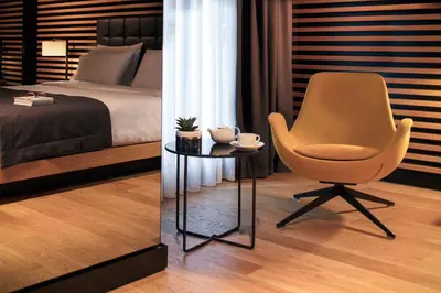 a bedroom with a chair and a table with a bed at Metropolitan Hotels Bosphorus - Special Category in Istanbul