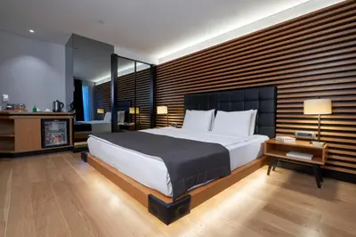 a bedroom with a large white bed and a table at Metropolitan Hotels Bosphorus - Special Category in Istanbul