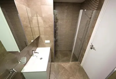 a bathroom with a sink and a shower at Uçar Royal Hotel ve Konferans Salonu in Sile