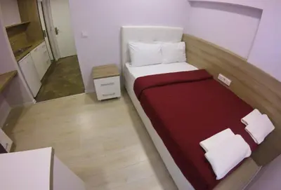 a small bedroom with a bed in a small room at Uçar Royal Hotel ve Konferans Salonu in Sile