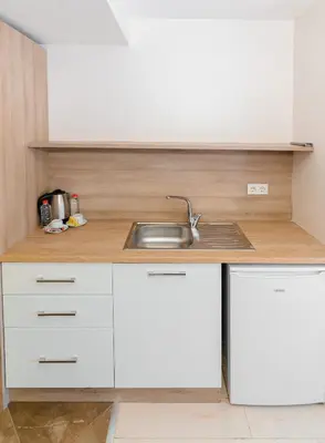 a kitchen with white cabinets and a sink at Uçar Royal Hotel ve Konferans Salonu in Sile
