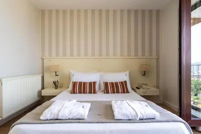 a bedroom with a large bed with two pillows at Tiara Buyukada in Buyukada