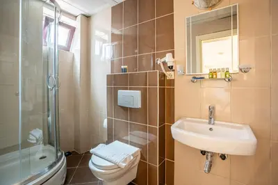 a bathroom with a toilet and a sink and a shower at Tiara Buyukada in Buyukada