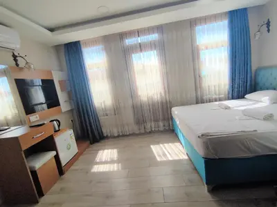 a hotel room with a bed and a television at Grafen House in Istanbul