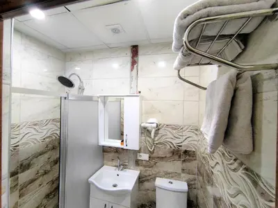 a bathroom with a sink and a toilet and towels at Grafen House in Istanbul