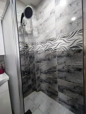 a shower with a glass door in a bathroom at Grafen House in Istanbul