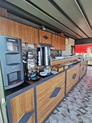 a large kitchen with wooden cabinets and a counter top at Apple Tree Hotel in Istanbul