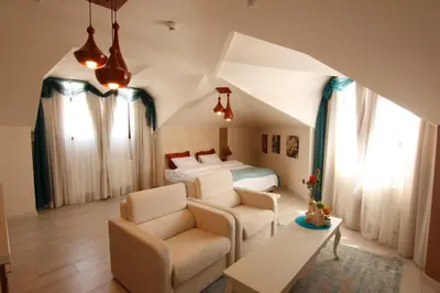 a bedroom with a bed and a couch and a table at Zin D Home Otel Cekmeköy in Istanbul