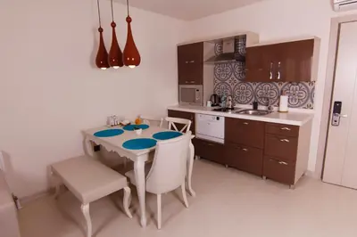 a kitchen with a table and chairs and a sink at Zin D Home Otel Cekmeköy in Istanbul
