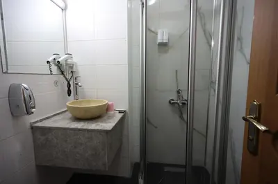a bathroom with a bowl sink and a shower at Arven Hotel in Istanbul