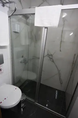 a bathroom with a glass shower with a toilet at Arven Hotel in Istanbul