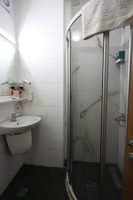 a bathroom with a shower and a toilet and a sink at Arven Hotel in Istanbul