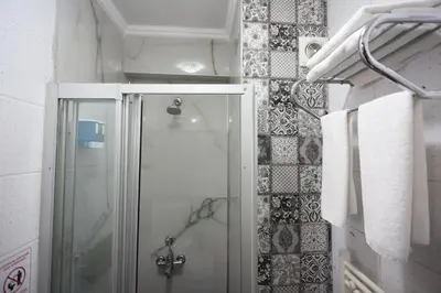 a shower with a glass door in a bathroom at Arven Hotel in Istanbul