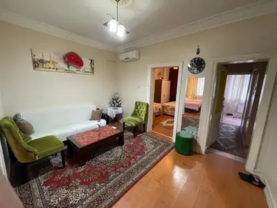 a living room with a white couch and green chairs at Villa Park Apart in Istanbul