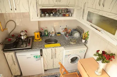 a small kitchen with a sink and a washing machine at Villa Park Apart in Istanbul
