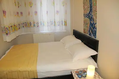 a bedroom with a bed with white sheets and pillows at Villa Park Apart in Istanbul