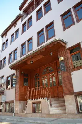 a building with a wooden door and stairs in front at Atlas Otel in Bursa