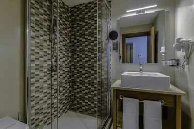 a bathroom with a sink and a glass shower at Hotel Venera Istanbul Old City in Istanbul