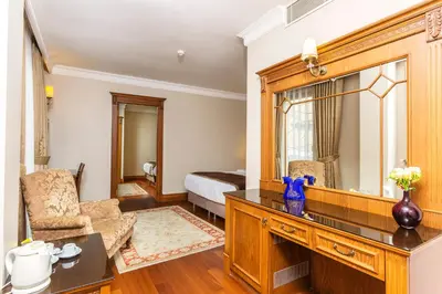 a living room with a large mirror and a bedroom at Acra Hotel - Special Category in Istanbul