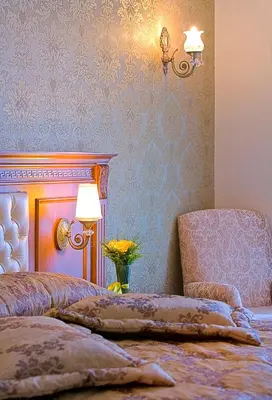 a bedroom with a bed and a lamp and a chair at Acra Hotel - Special Category in Istanbul