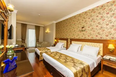 a hotel room with two beds and a desk at Acra Hotel - Special Category in Istanbul